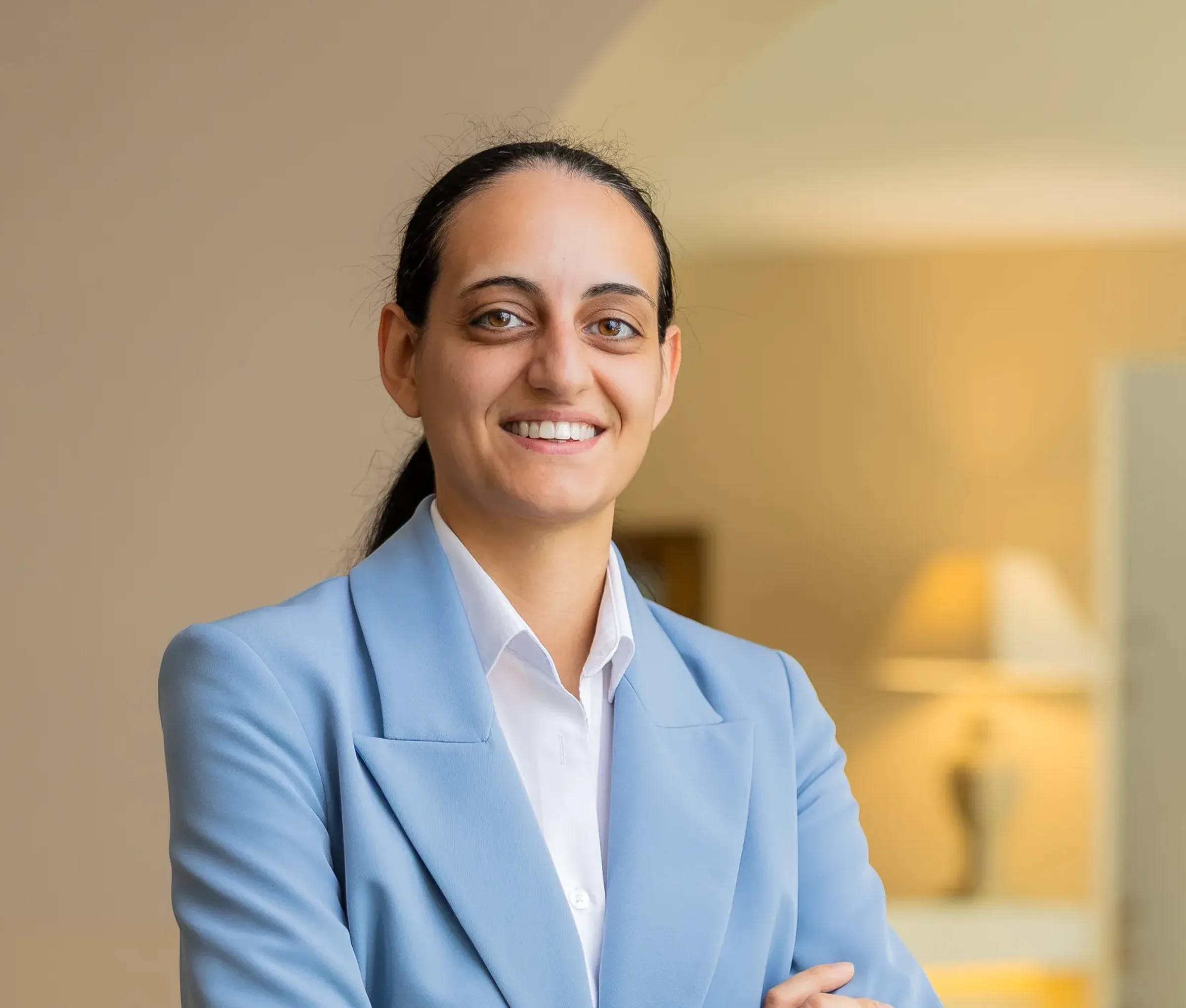 Smiling woman in a blue blazer in a professional setting